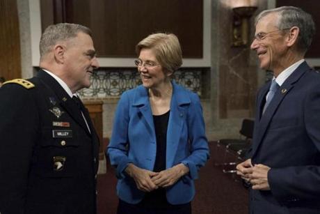Senate Armed Services Committee member Sen. Elizabeth Warren, D-Mass., center, talks with acting Army Secretary Robert Speer, right, and Army Chief of Staff Gen. Mark Milley on Capitol Hill in Washington, Thursday, May 25, 2017, prior to the start of the committee's hearing on the Army's fiscal 2018 budget. (AP Photo/Andrew Harnik)
