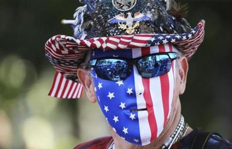 SLIDER. Boston, MA- July 04, 2017: Kevin Brown wears a patriotic mask while waiting for his daughter to arrive before the Boston Pops Fireworks Spectacular in Boston, MA on July 4, 2017. (CRAIG F. WALKER/GLOBE STAFF) section: metro reporter:
