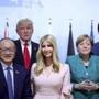 From left: Japanese Prime Minister Shinzo Abe, World Bank Group president, Jim Yong Kim, U.S. president Donald Trump, his daughter Ivanka, German chancellor Angela Merkel and Canada's Prime Minister Justin Trudeau, pose for media at a panel discussion during the G-20 summit in Hamburg, Germany, Saturday, July 8, 2017. (Michael Kappeler/Pool Photo via AP)