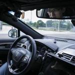 Shoabing Xu, a postdoctoral research fellow, sat in the driver?s seat as a safety precaution during a demonstration of an autonomous car at the MCity testing grounds at the University of Michigan in Ann Arbor, Mich.