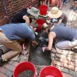 Volunteers worked in an exploratory trench on Monday outside a home once owned by Paul Revere?s cousin. The home was built in 1711.