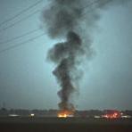 Smoke and flames rose from a military plane that crashed in a farm field, in Itta Bena, Miss., killing several. 