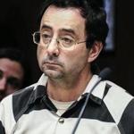 FILE - In this Feb. 17, 2017, file photo, Dr. Larry Nassar listens to testimony of a witness during a preliminary hearing, in Lansing, Mich. Nassar, a former Michigan State University and USA Gymnastics sports doctor, is taking a step toward resolving one of four criminal cases against him in Michigan. Nassar is due in federal court Tuesday, July 11, to plead guilty to child pornography charges. It?s separate from sexual assault charges involving women and girls who said they were molested when they sought treatment for gymnastics injuries. (Robert Killips/Lansing State Journal via AP, File)