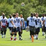 Foxborough-06/08/2017- Patriots minicamp at the Gillette Stadium practice field. A helmet is thrown in the air over the offensive linemen at the end of practice as they walk off the field. John Tlumacki/The Boston Globe