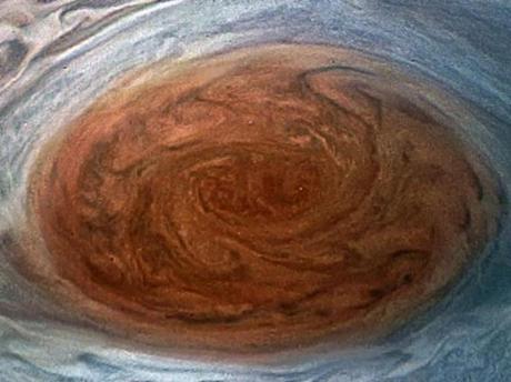 An artist's conception of the Juno spacecraft flying over the Great Red Spot. The image of Jupiter is not a painting ? it's a mosaic made from real data taken by the Voyager spacecraft.
