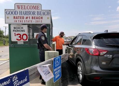 Gloucester, MA: 07-1-2017: Gloucester police officer Al D'Angelo (left) and parking attendant Jack Doyle man the booth at the entrance to the parking lot at Good Harbor Beach in Gloucester, Mass. July 1, 2017. When the photo was taken just after 11am, the lot was still open to non-resident visitors paying to park. Photo/John Blanding, Boston Globe staff story/Hattie Bernstein, NOWK ( 16zobeaches )
