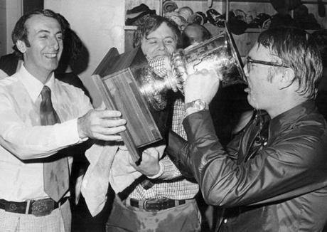 Owner Bob Schmertz (left), president Howard Baldwin (center), and coach Jack Kelly (right) with the stand-in for the Avco Cup after winning the WHA title on May 6, 1973.
