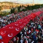 People stood under Turkish flags as they gathered on the Martyrs? Bridge in Istanbul.