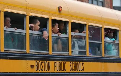 BOSTON, MA - 6/09/2016: A Boston Public school bus with elementry school children look out their windows view the shooting scene and media as their bus passes near the Jeremiah Burke High school where yesterday a fatal student shooting of a 17-year-old student was killed and three other people were wounded in a shooting on Washington Street in Dorchester Wednesday afternoon. (David L Ryan/Globe Staff Photo) SECTION: METRO TOPIC 10shootingpic
