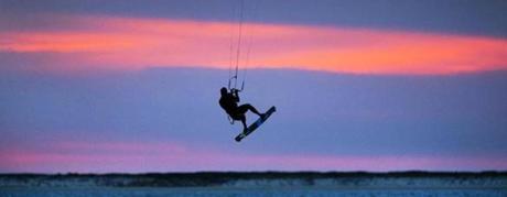 Juraj Bencat of KiteTucket Kiteboarding School rides the wind off Pocomo Point after sunset.
