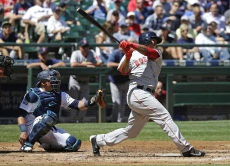 Boston Red Sox's Rafael Devers follows through after hitting a solo home run -- his first major-league hit -- in the third inning of a baseball game against the Seattle Mariners, Wednesday, July 26, 2017, in Seattle. (AP Photo/Ted S. Warren)

