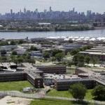 The Rikers Island jail complex stands in New York with the Manhattan skyline in the background in a June 2014 file photo.