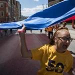 Kayleen Aponte chanted during the 50th annual Puerto Rican Festival parade, which began at the Hynes Convention Center on Sunday.