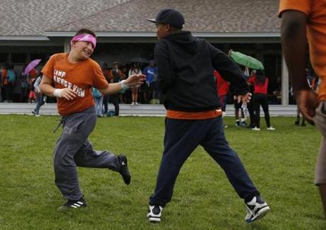 Kevin Alas, 12, of East Boston (left) is tagged as campers play a game of sharks vs. fish. 
