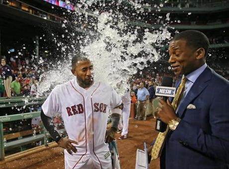 Boston MA 07/29/17 Boston Red Sox Eduardo Nunez is doused with water from teammate Hanley Ramirez as NESN's Jahmai Webster avoids the dunking after Nunez made the game winning hit against the Kansas City Royals during tenth inning action at Fenway Park. (Matthew J. Lee/Globe staff) topic: reporter: 
