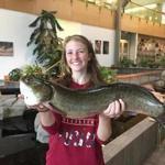 Tauri Adamczyk, 16, of Taunton, held her record-setting bowfin catch.