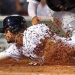 Boston-8/03/17-Red Sox vs White Sox- JRed Sox Xander Bogaerts slides safely into home, as dirts flys around him, on a 6th inning double hit by Sox Mitch Moreland as White Sox catcher Omar Narvaez gets the throw. John Tlumacki/Globe Staff(sports)