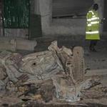 A Somali policeman walks near the wreckage of the car bomb that was detonated in Mogadishu, Somalia Friday, Aug 4, 2017. At least two people were killed and several others wounded in the blast in Somalia's capital, police said. (AP Photo/Farah Abdi Warsameh)