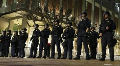 In this Feb. 1, 2017 file photo, University of California at Berkeley police guard the building where Milo Yiannopoulos was to speak. 
