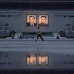 Pedestrians and vehicles passed the portraits of late North Korean leaders Kim Il-Sung (L) and Kim Jong-Il (R) in Pyongyang.