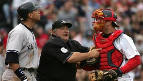 Umpire Bruce Froemming tries to keep Alex Rodriguez and Jason Varitek separated in 2004.
