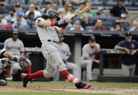 Boston Red Sox's Andrew Benintendi hits a three-run home run during the third inning of a baseball game, Saturday, Aug. 12, 2017, in New York. (AP Photo/Frank Franklin II)
