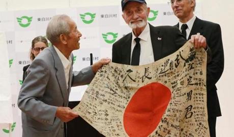 Sayoko Furuta, 93, was comforted by World War II veteran Marvin Strombo, after he returned a Japanese flag with autographed messages that was owned by her brother Sadao Yasue. 
