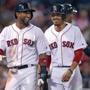Boston, MA: August 15, 2017: The Red Sox Eduardo Nunez (left) and Mookie Betts (right) scored on a bottom of the fifth inning double by Hanley Ramirez off of Cardinals starting pitcher Mike Leake the first two of the eight runs Boston scored in the frame. The Boston Red Sox hosted the St. Louis Cardinals in a regular season inter league MLB baseball game at Fenway Park. (Jim Davis/Globe Staff).