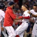 Boston, MA: August 16, 2017: The Red Sox Mookie Betts (second from right) is mobbed by teammates after his game winning The Boston Red Sox hosted the St. Louis Cardinals in a regular season inter league MLB baseball game at Fenway Park. (Jim Davis/Globe Staff). 