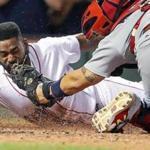 Boston, MA: August 16, 2017: The Red Sox Jackie Bradley, Jr. dives head first and beats the tag of Cardinals catcher Yadier Molina, who couldn't hold on to the ball as he scores the game winning run in the bottom of the ninth inning on a hit by teammate Mookie Betts. The Boston Red Sox hosted the St. Louis Cardinals in a regular season inter league MLB baseball game at Fenway Park. (Jim Davis/Globe Staff).