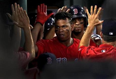 Red Sox rookie Rafael Devers (11) is congratulated after his two-run home run, his seventh round-tripper in 19 games.
