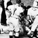 Boston, MA - 8/18/1967: Boston Red Sox player Tony Conigliaro is surrounded by teammates after being hit on the head by a fourth-inning fast ball from Jack Hamilton of the California Angels, during at game at Fenway Park in Boston on August 18, 1967. Conigliaro suffered a fractured cheekbone and scalp contusion. (Charles B. Carey/Globe Staff) --- BGPA Reference: 140404_CB_019