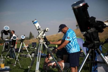 People set up cameras and telescopes to watch the solar eclipse at South Mike Sedar Park in Casper, Wyo. on Monday.

