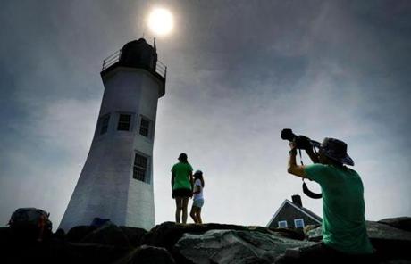 ECLIPSE SLIDER6 Scituate-8/21/17 People gathered on the breakwater around the Old Scituate Lighhouse to photograph and look at the solar eclipse. John Tlumacki/Globe Staff(metro)
