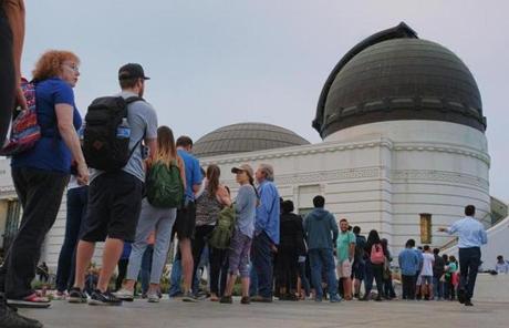 ECLIPSE SLIDER1 People wait in line to buy viewing glasses for the eclipse at the Griffith Observatory in Los Angeles early Monday, Aug. 21, 2017. (AP Photo/Richard Vogel)

