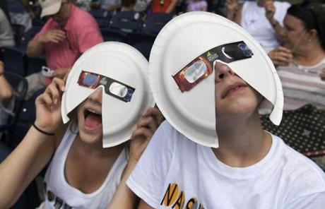 ECLIPSE SLIDE5 Annie Gray Penuel and Lauren Peck, both of Dallas, wear their makeshift eclipse glasses at Nashville's eclipse viewing party ahead of the solar eclipse at First Tennessee Park on Monday, Aug. 21, 2017, in Nashville, Tenn. (Shelley Mays/The Tennessean via AP)
