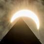 The moon eclipsed the sun above the Washington Monument on Monday.