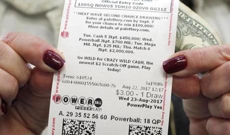 Jackie Haaf, 58, of Erie, Pa., shows off her Powerball ticket at a convenience store in Summit Township, Pa., on Tuesday.

