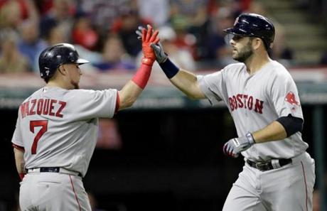 Boston Red Sox's Mitch Moreland, right, is congratulated by Christian Vazquez after Moreland hit a solo home run off Cleveland Indians starting pitcher Corey Kluber in the fifth inning of a baseball game, Wednesday, Aug. 23, 2017, in Cleveland. (AP Photo/Tony Dejak)
