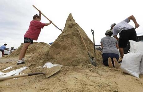 HARVEY SLIDER4 Residents fill sand bags as they prepare for Hurricane Harvey, Thursday, Aug. 24, 2017, in Corpus Christi, Texas. Two counties have ordered mandatory evacuations as Hurricane Harvey gathers strength as it drifts toward the Texas Gulf Coast. (AP Photo/Eric Gay)
