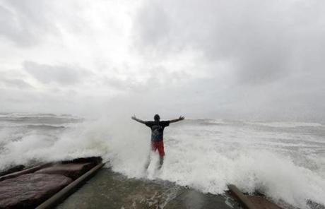 HARVEY SLIDER3 Luis Perez watches waves crash again a jetty in Galveston, Texas as Hurricane Harvey intensifies in the Gulf of Mexico Friday, Aug. 25, 2017. Harvey is forecast to be a major hurricane when it makes landfall along the middle Texas coastline. (AP Photo/David J. Phillip)
