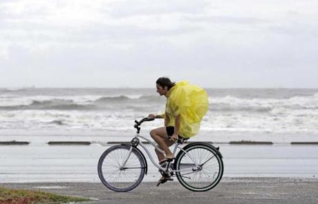 HARVEY SLIDER3 Emma Jewell rides her bicycle along Seawall Blvd. in Galveston, Texas as Hurricane Harvey intensifies in the Gulf of Mexico Friday, Aug. 25, 2017. Harvey is forecast to be a major hurricane when it makes landfall along the middle Texas coastline. (AP Photo/David J. Phillip)
