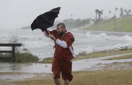 HARVEY SLIDER3 Matt Looingvill struggles with his umbrella as he tries to walk in the wind and rain, Friday, Aug. 25, 2017, in Corpus Christi, Texas. Harvey intensified into a hurricane Thursday and steered for the Texas coast with the potential for up to 3 feet of rain, 125 mph winds and 12-foot storm surges in what could be the fiercest hurricane to hit the United States in almost a dozen years.(AP Photo/Eric Gay)
