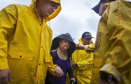 HARVEY SLIDER4 Corpus Christi firefighters help Guadalupe Guerra walk to a bus headed for San Antonio at an evacuation center in Corpus Christi, Texas, on Friday, Aug. 25, 2017. Conditions deteriorated Friday along the Texas Gulf Coast as Hurricane Harvey strengthened and crawled toward the state, with forecasters warning that evacuations and preparations 