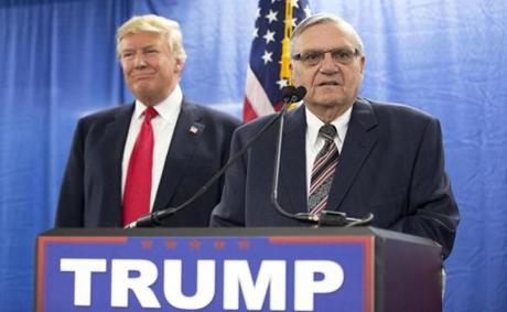 FILE - In this Jan. 26, 2016, file photo, then-Republican presidential candidate Donald Trump is joined by Joe Arpaio, the then sheriff of metro Phoenix, during a news conference in Marshalltown, Iowa. Trump isn't expected to take action Tuesday, Aug. 22, 2017, on a possible pardon of Arpaio's conviction for intentionally disobeying a judge's order in an immigration case. White House press secretary Sarah Huckabee Sanders told reporters that the president would take no action Tuesday on Arpaio as Trump plans to appear in the evening at a rally in downtown Phoenix. (AP Photo/Mary Altaffer, File)
