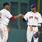 Boston, MA: July 31, 2017: Two of the newest members of the Red Sox, rookie Rafael Devers (left) and veteran Eduardo Nunez (right) congratulate each other following Boston's 6-2 victory on Monday night. The Boston Red Sox hosted the Cleveland Indians in a regular season MLB baseball game at Fenway Park. (Jim Davis/Globe Staff). 