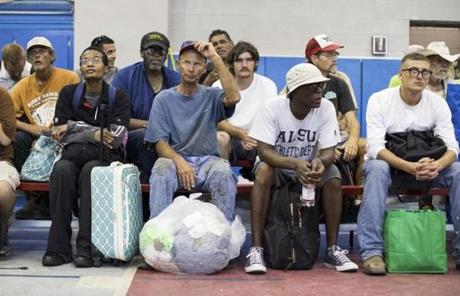Residents waited inside the Corpus Christi Natatorium to board a bus to evacuate to San Antonio ahead of Hurricane Harvey.

