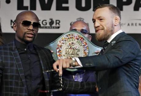 Floyd Mayweather Jr., left, and Conor McGregor pose for photographers during a news conference Wednesday, Aug. 23, 2017, in Las Vegas. The two are scheduled to fight in a boxing match Saturday in Las Vegas. (AP Photo/John Locher)
