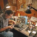 Tom Furrier, the last typewriter repairman in the area, works on a vintage Corona in his Arlington shop. Many of his old machines, such as the Royals and Remington Rand below, are used for parts.