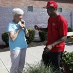 Sister Nancy Braceland tasted a chive with Randy Thompson, who works at the BCYF Flaherty Pool.